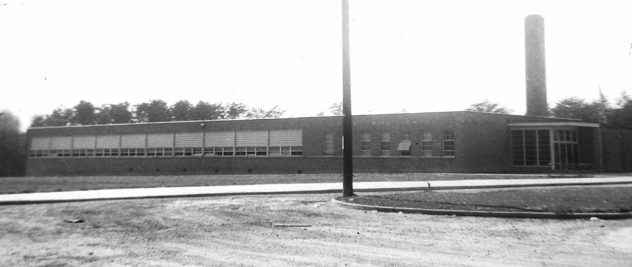 Black and white photograph of Drew-Smith Elementary School. The building is a single-story concrete structure with a brick veneer. It had fewer classrooms and amenities than the schools built for white children during this time period.  