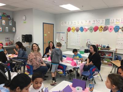 photo of kindergarten students having muffins with mom