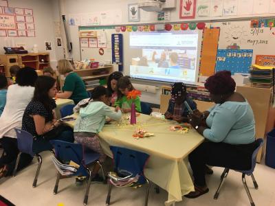 photo of kindergarten students having muffins with mom