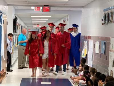 photo of graduates visiting the school